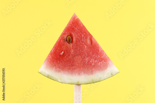 Watermelon slice on a stick.