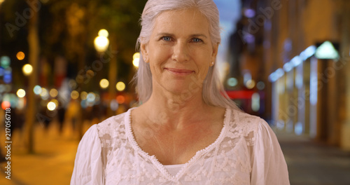 Casual portrait of lovely senior woman laughing on Champs Elysees avenue
