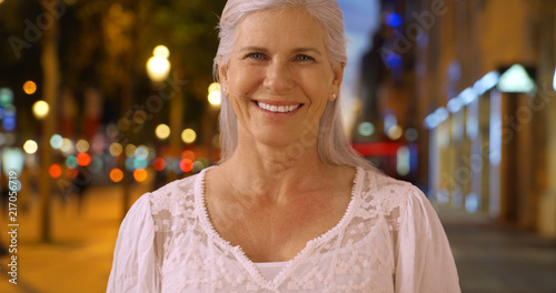 Casual portrait of lovely senior woman laughing on Champs Elysees avenue