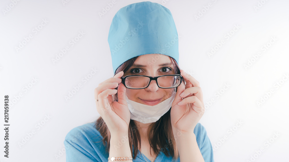 Portrait of a friendly smiling doctor woman or nurse in blue medical uniform, isolated on white background with copy space. Healthcare and medicine concept Portrait of a friendly smiling doctor woman or nurse in blue medical uniform, isolated on white background with copy space. Healthcare and medicine concept