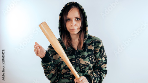 Pretty girl holding baseball bat isolated on white photo