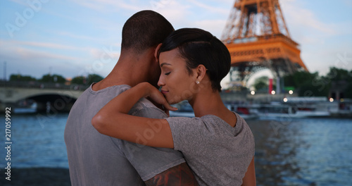 Wall Mural Traveling African-American couple enjoying view of Eiffel Tower together