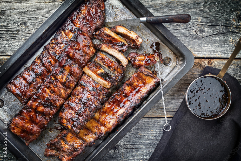 Barbecue spare ribs St Louis cut with hot honey chili marinade as top view in a rustic skillet - obrazy, fototapety, plakaty 