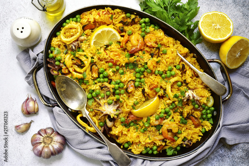 Classic valencian paella from rice with seafood and green pea - traditional dish of spanish cuisine.Top view.