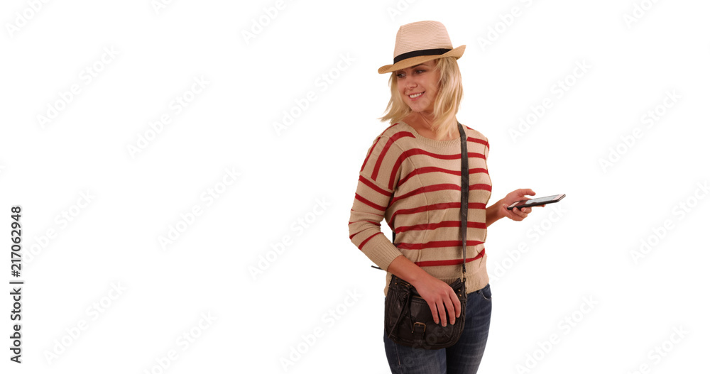 Fashionable female hipster with smartphone enjoying herself on white background Fashionable female hipster with smartphone enjoying herself on white background