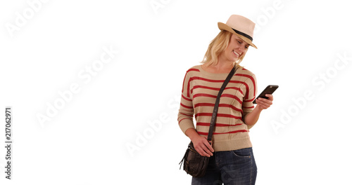 Portrait of happy blonde female hipster using phone on solid white copy space