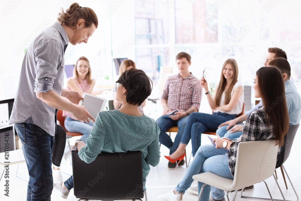 Male business trainer giving lecture in office