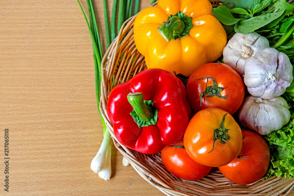 Organic vegetables in the wicker basket on wooden background Organic vegetables in the wicker basket on wooden background