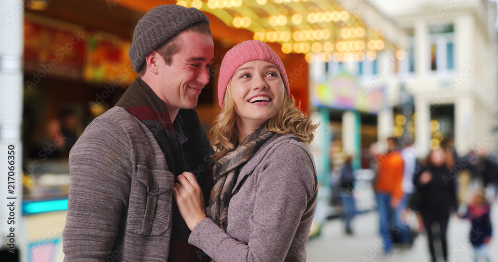Happy Caucasian couple outdoors in winter clothes smiling and being affectionate Happy Caucasian couple outdoors in winter clothes smiling and being affectionate