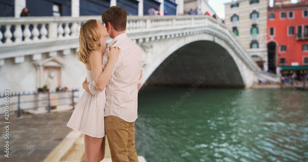 Young married couple by Rialto Bridge hugging and kissing Young married couple by Rialto Bridge hugging and kissing