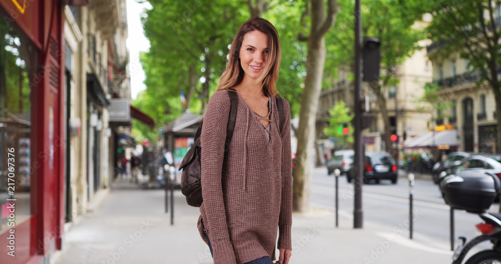 Casual portrait of woman on Paris street smiling and laughing