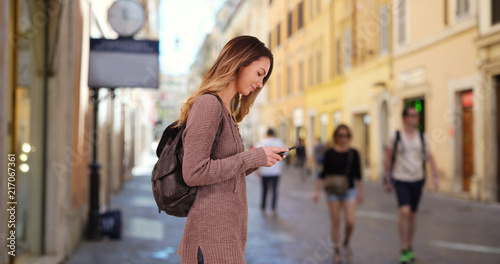 Photography Pretty Caucasian woman on Roman street using map on cellphone