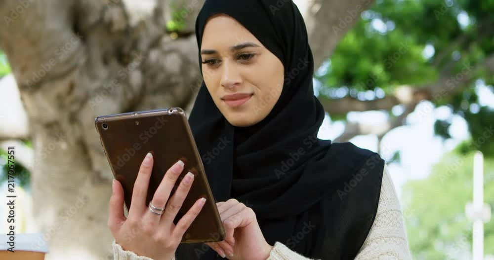 Woman in hijab using digital tablet 4k Woman in hijab using digital tablet 4k
