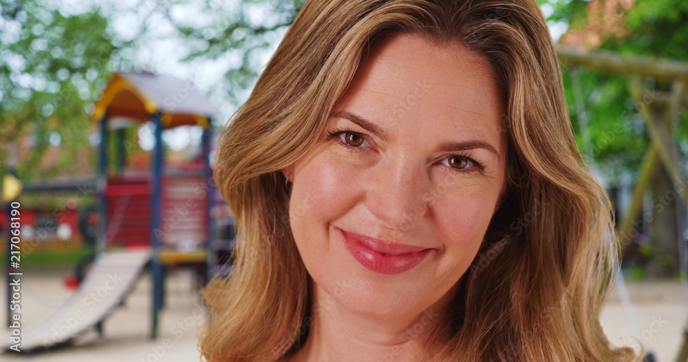 Obraz premium Close up of Caucasian woman with bright smile outside at park
