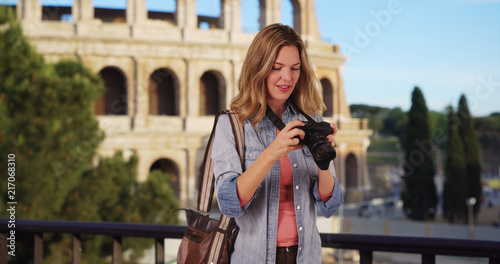 Travel photographer in Rome taking picture outside smiling