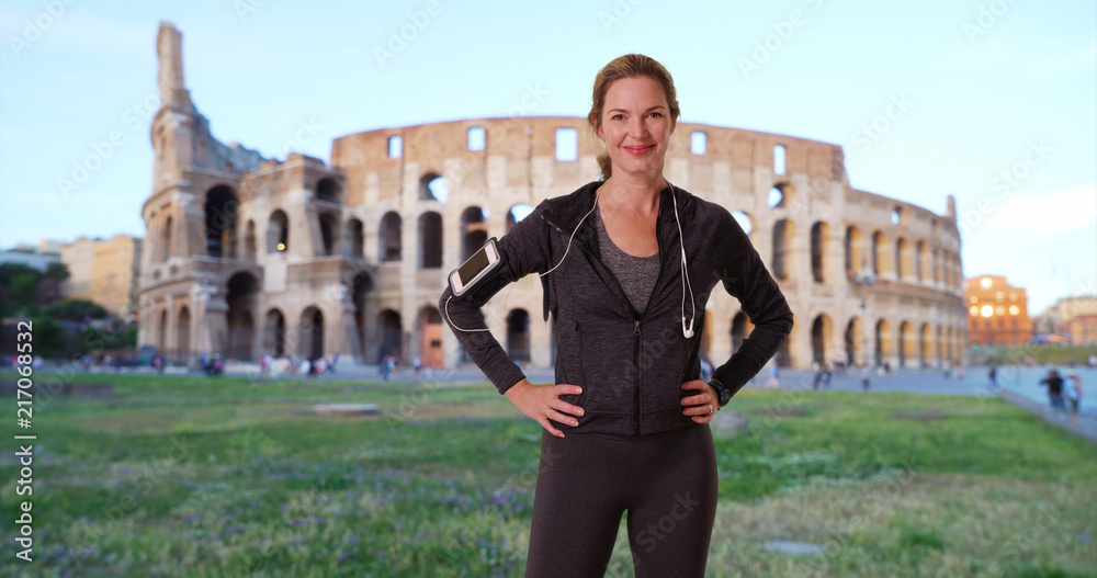 Portrait of healthy woman jogger in Rome smiling directly at camera