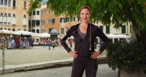 Healthy active woman jogger in Venice smiling directly at camera