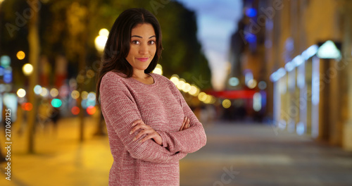 Pretty Latin woman posing for a portrait outside at night © rocketclips
