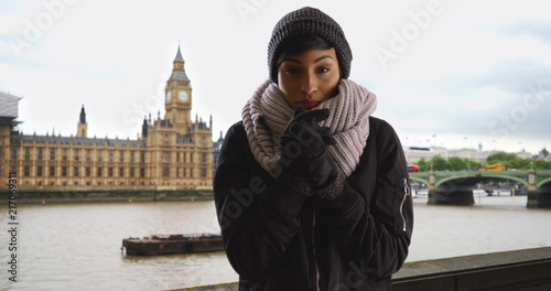Εκτύπωση καμβά Pretty woman wearing cozy hat and scarf on overcast day in London England
