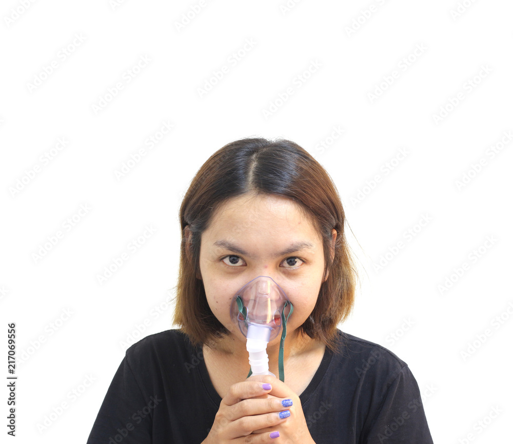 Young woman using nebulizer for asthma and respiratory diseases at home on white background
