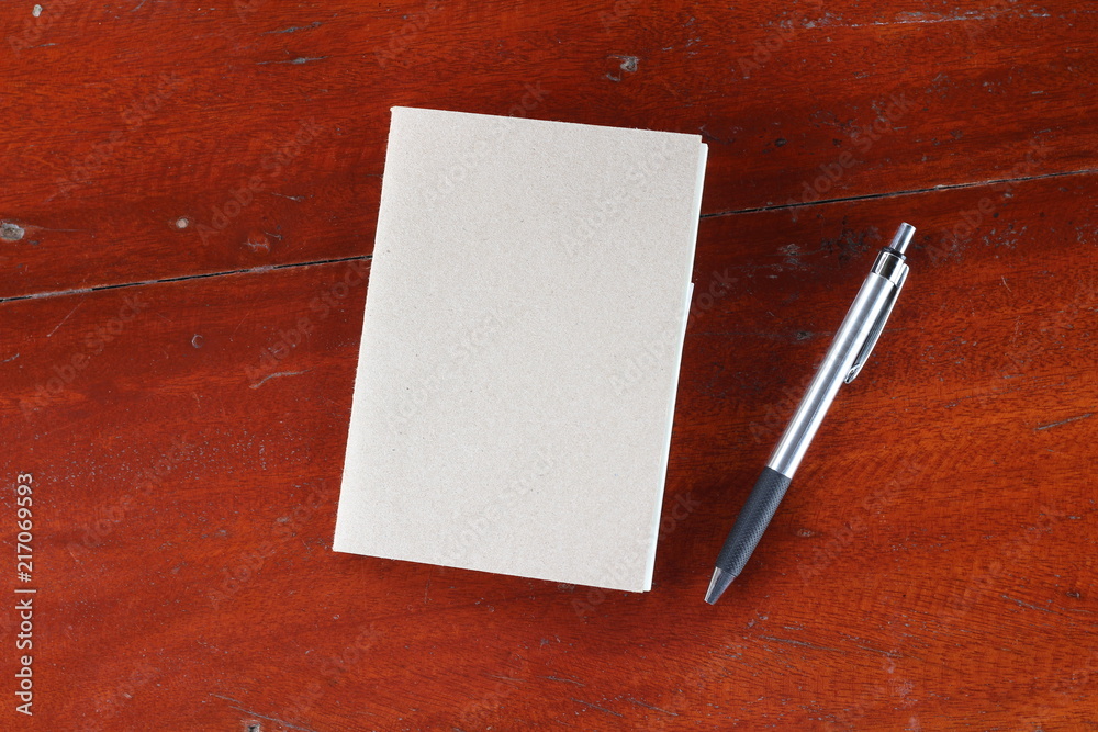 Pen and Notepad on the wooden background Pen and Notepad on the wooden background