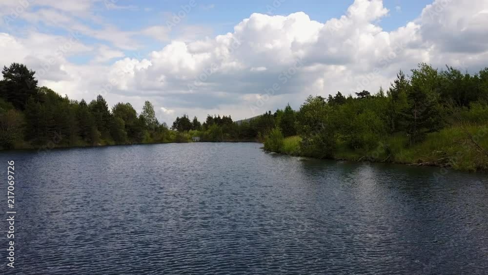 Drone shot over lake surrounded by trees forest in Svit, Poprad Slovakia, by the foot of the Tatra mountains. Day time Drone shot over lake surrounded by trees forest in Svit, Poprad Slovakia, by the foot of the Tatra mountains. Day time