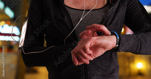 Close up of fit senior woman using activity tracker © rocketclips