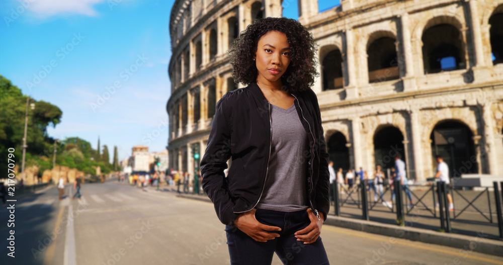 Gorgeous young black woman with short curls smiling in Rome