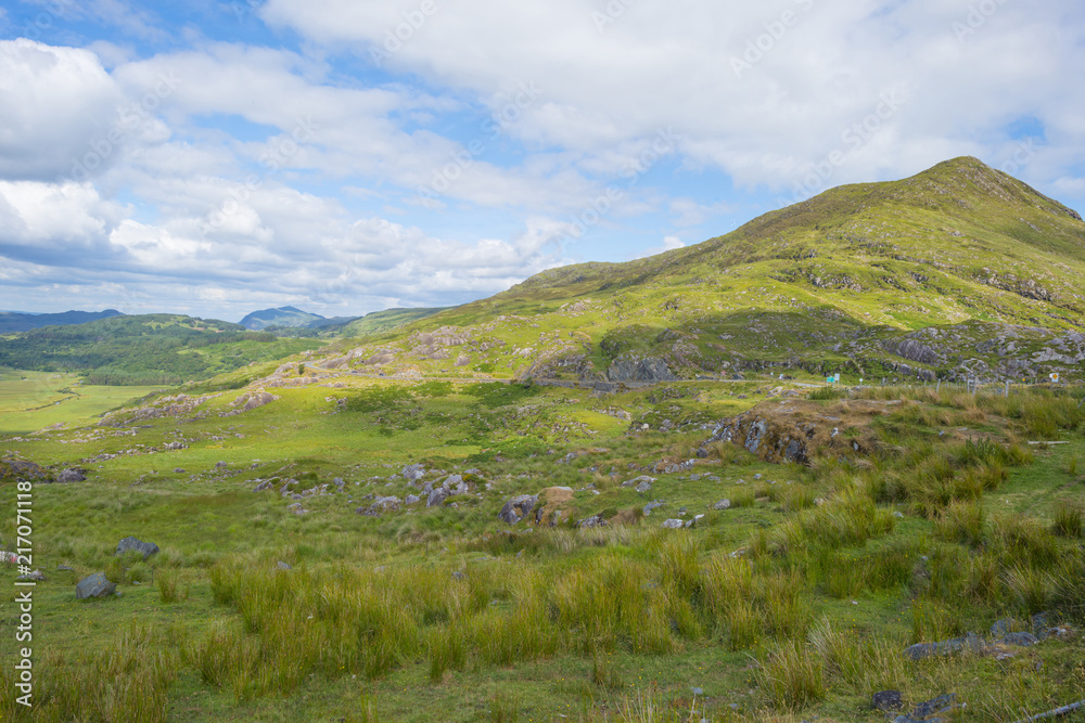 Scenic panorama of green mountains below a blue cloudy sky in summer Scenic panorama of green mountains below a blue cloudy sky in summer
