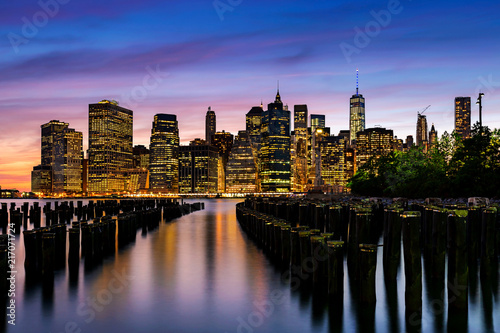 Lower Manhattan skyline view from Brooklyn Bridge Park waterfront at sunset