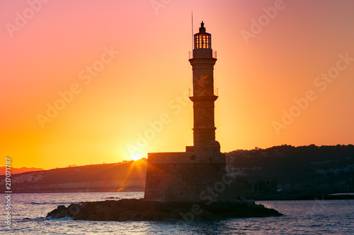 Lighthouse in old harbour of Chania at sunrise, Crete, Greece