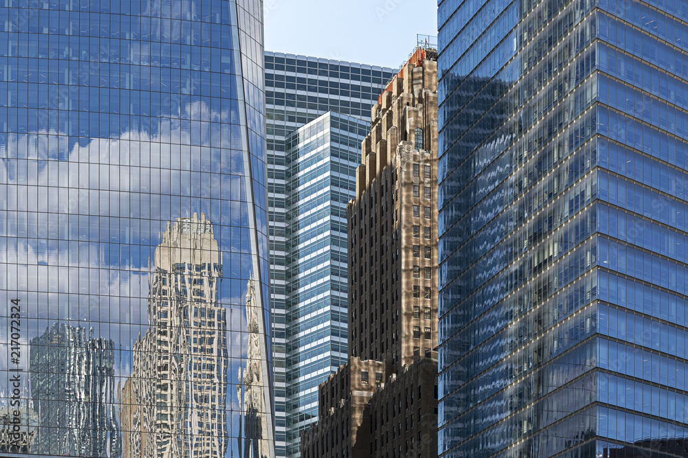 Fototapeta premium New York City / USA - JUL 19 2018: Abstract Reflections Glass Building Exterior in World Trace Center Lower Manhattan