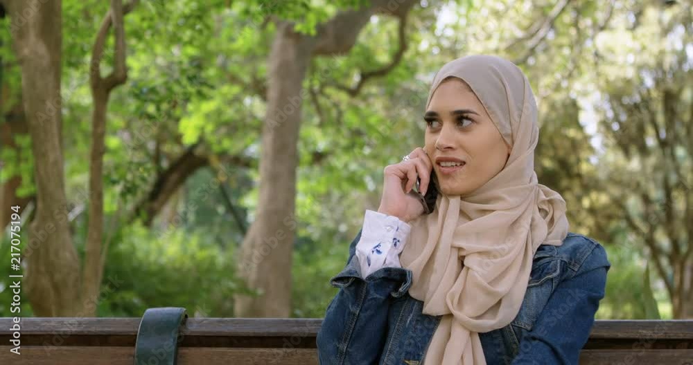 Woman in hijab talking on mobile phone 4k Woman in hijab talking on mobile phone 4k