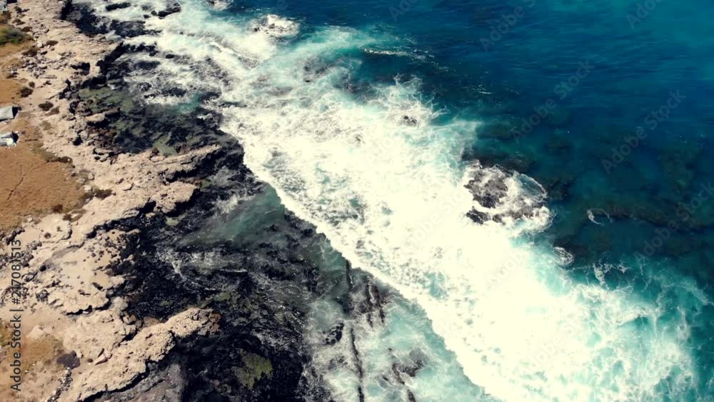 Overhead aerial view of ocean waves splashing against the rocks on the West shore of Oahu, Hawaii. Overhead aerial view of ocean waves splashing against the rocks on the West shore of Oahu, Hawaii.
