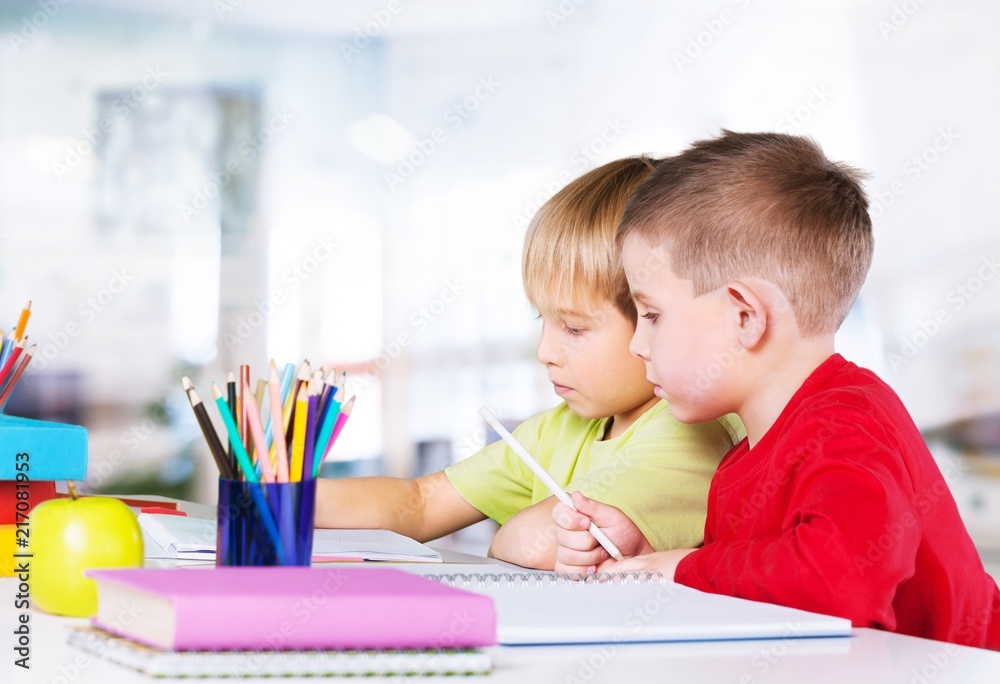 Two little boys studying subject on background Two little boys studying subject on background