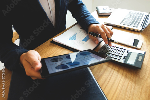  Businessman using tablet to the situation on the market value , Business concept. photo