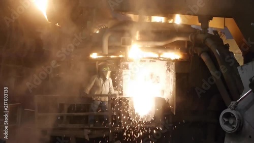 Steelworker pouring steel photo