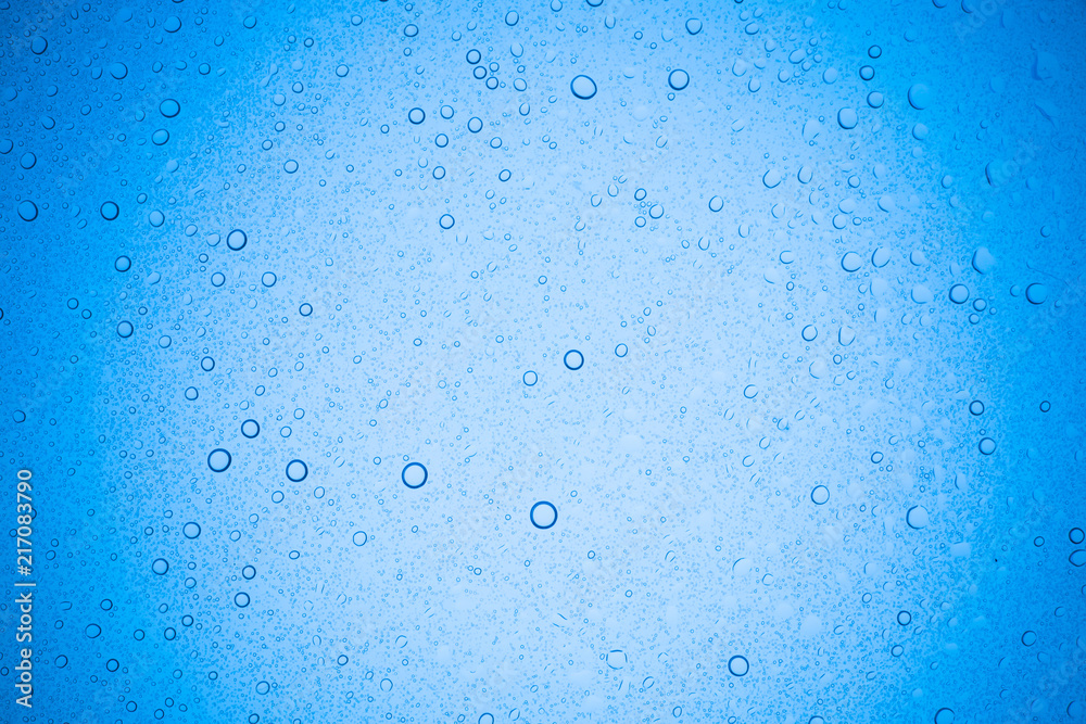 Rain droplets on blue glass background, Water drops on glass. Rain droplets on blue glass background, Water drops on glass.