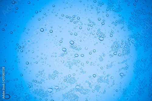 Rain droplets on blue glass background  Water drops on glass.