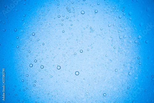Rain droplets on blue glass background, Water drops on glass.