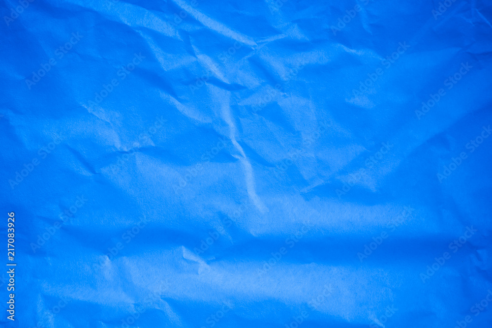 Obraz premium Crumpled blue paper background.