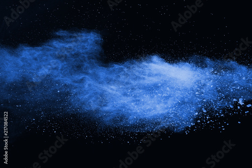 Blue powder explosion on black background. Colored cloud. Colorful dust explode. Paint Holi. © kitsana