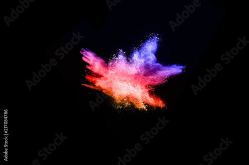 abstract colored dust explosion on a black background.abstract powder splatted background Freeze motion of color powder exploding throwing color powder  multicolored glitter texture.