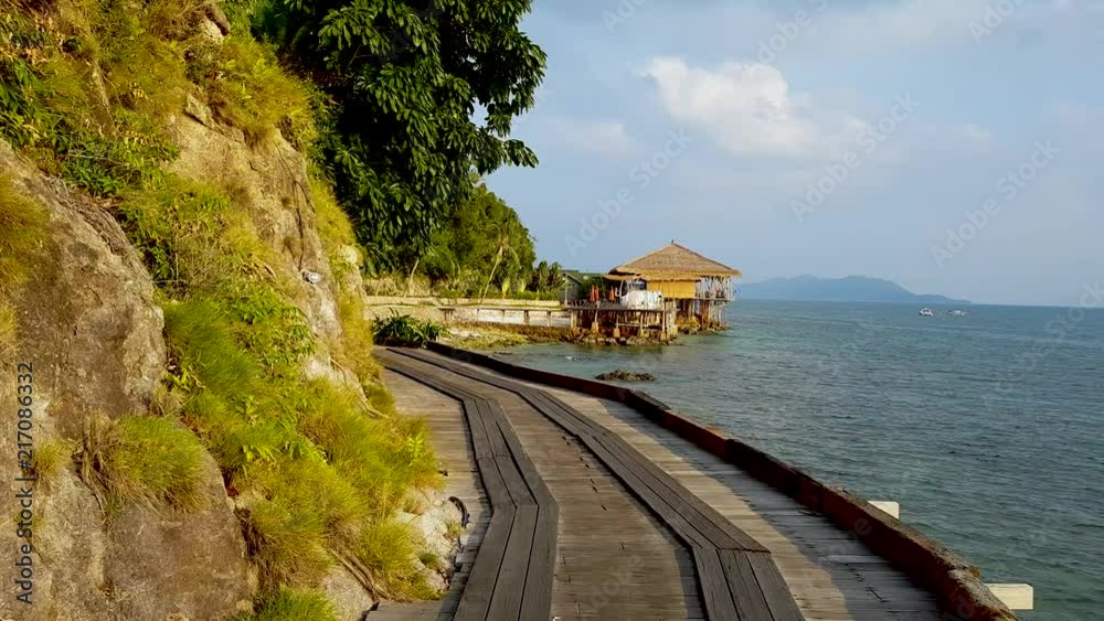 Rising view of a cliff side ocean view of and island at sunset. Warm summer vacation feelings. Rising view of a cliff side ocean view of and island at sunset. Warm summer vacation feelings.