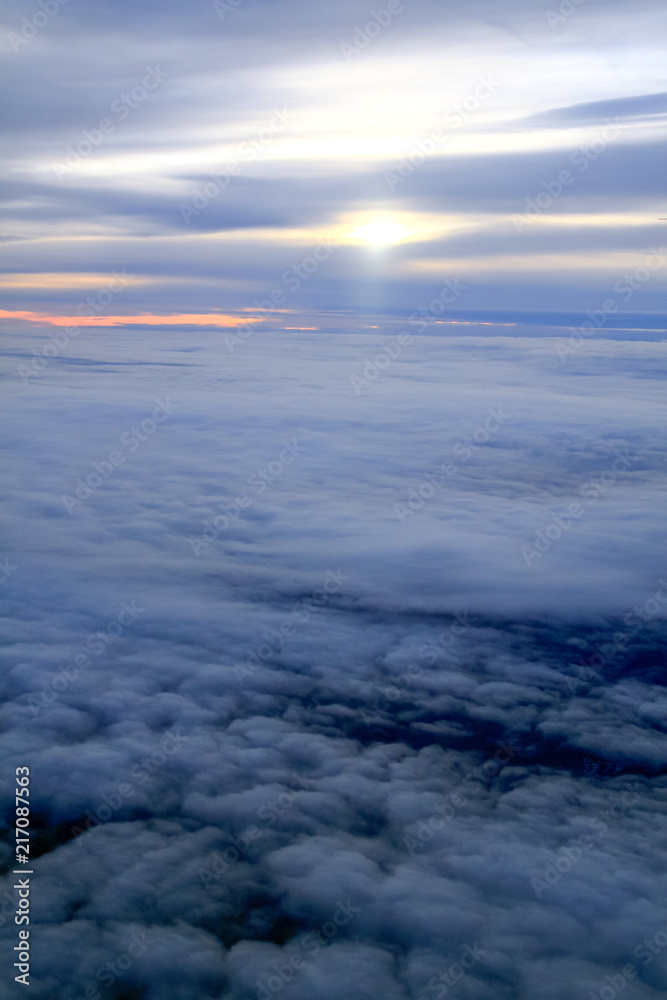 Obraz premium Sunset Over Sea of Clouds and Horizon line from a Plane.