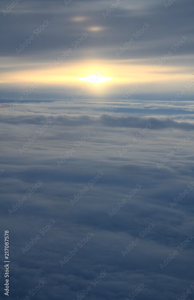 Sunset Over Sea of Clouds and Horizon line from a Plane.