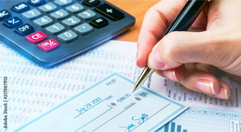 Business man prepare writing a check on