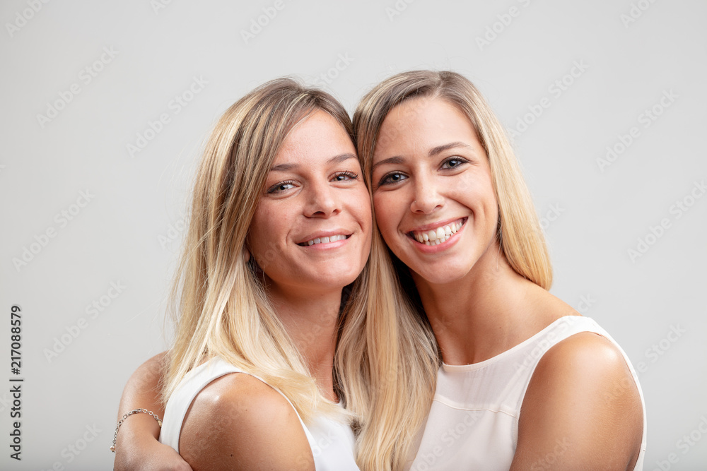 Two young blond women in a close embrace Two young blond women in a close embrace