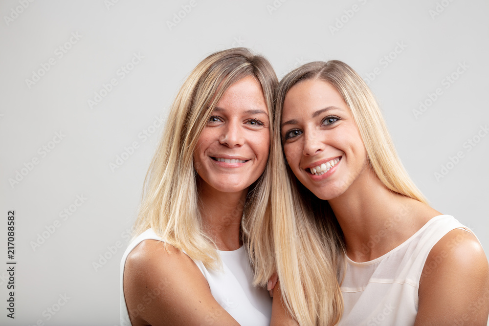 Two happy smiling women with long blond hair Two happy smiling women with long blond hair