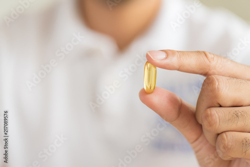 Close up man hand holding pills. Health care and medical concept.